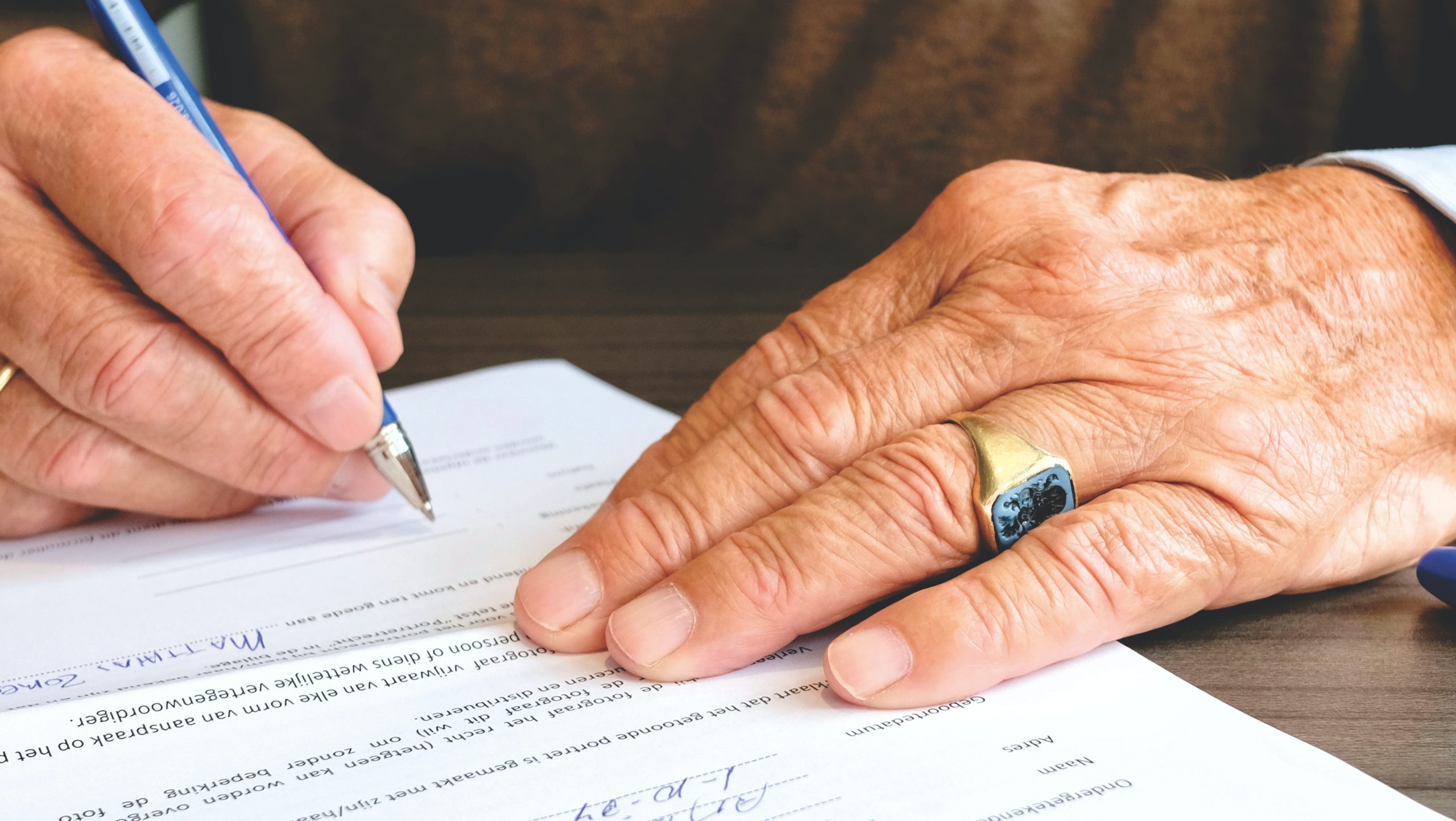 Person signing paper